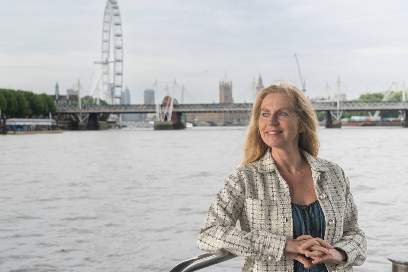 Woman outside deck with London Eye in the background